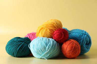 Many different yarns on yellow background, closeup