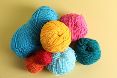 Photo of Many different yarns on yellow background, flat lay