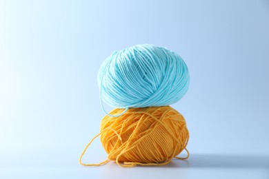 Photo of Colorful yarns on light background. Knitting material