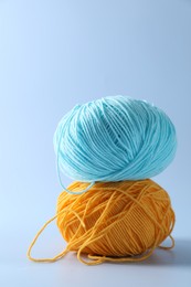 Photo of Colorful yarns on light background. Knitting material