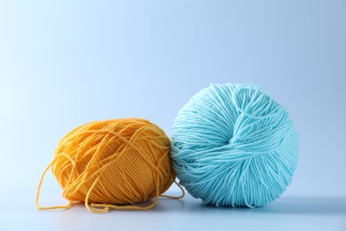 Photo of Colorful yarns on light background. Knitting material