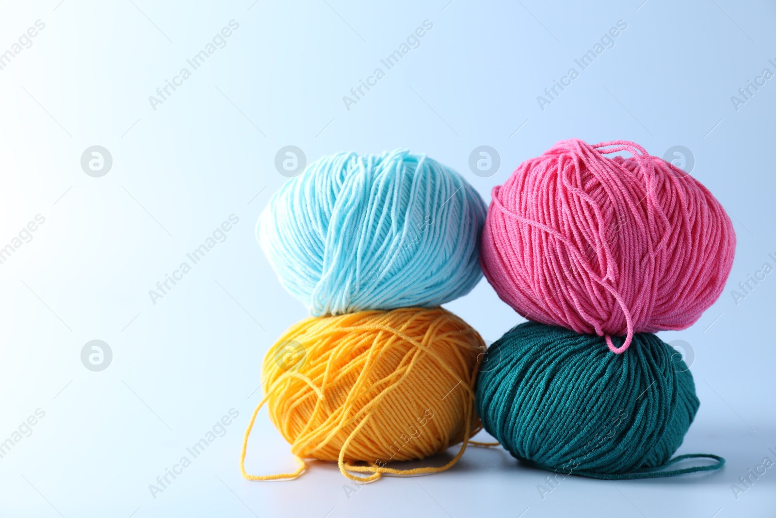 Photo of Colorful yarns on light background. Space for text