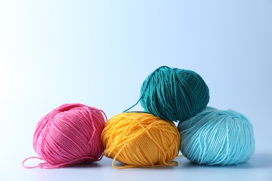 Photo of Different colorful yarns on light background. Knitting material