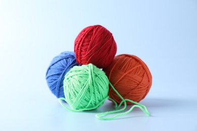 Photo of Different colorful yarns on light background. Knitting material