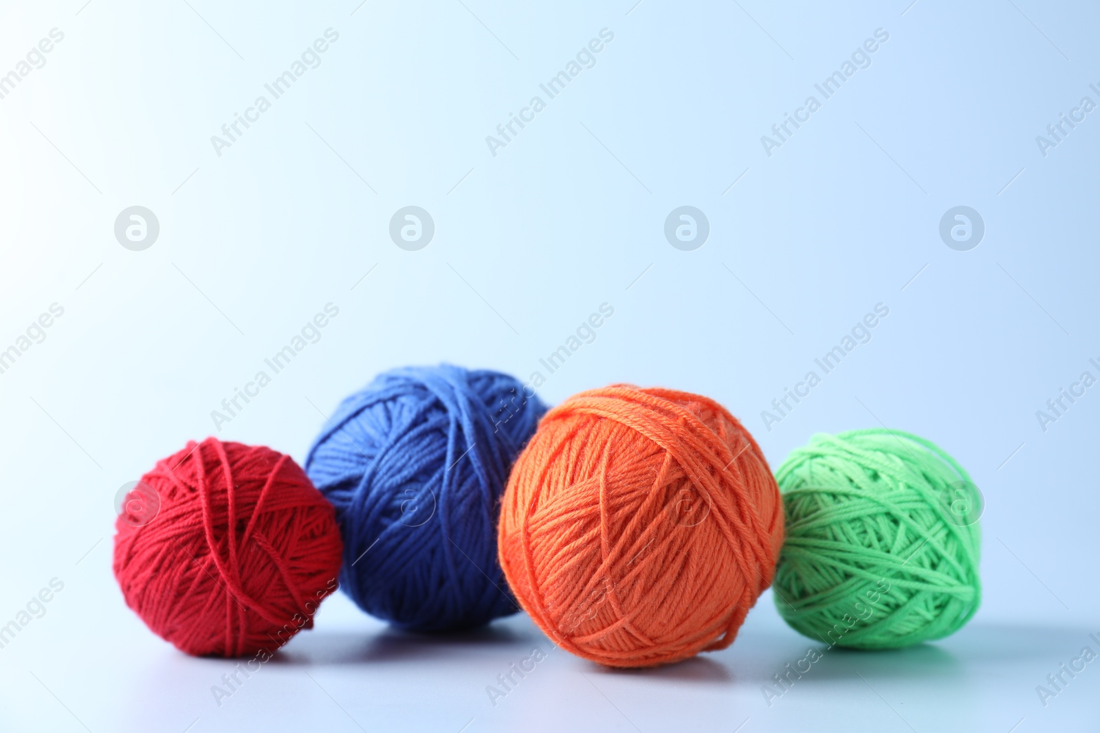 Photo of Different colorful yarns on light background. Space for text