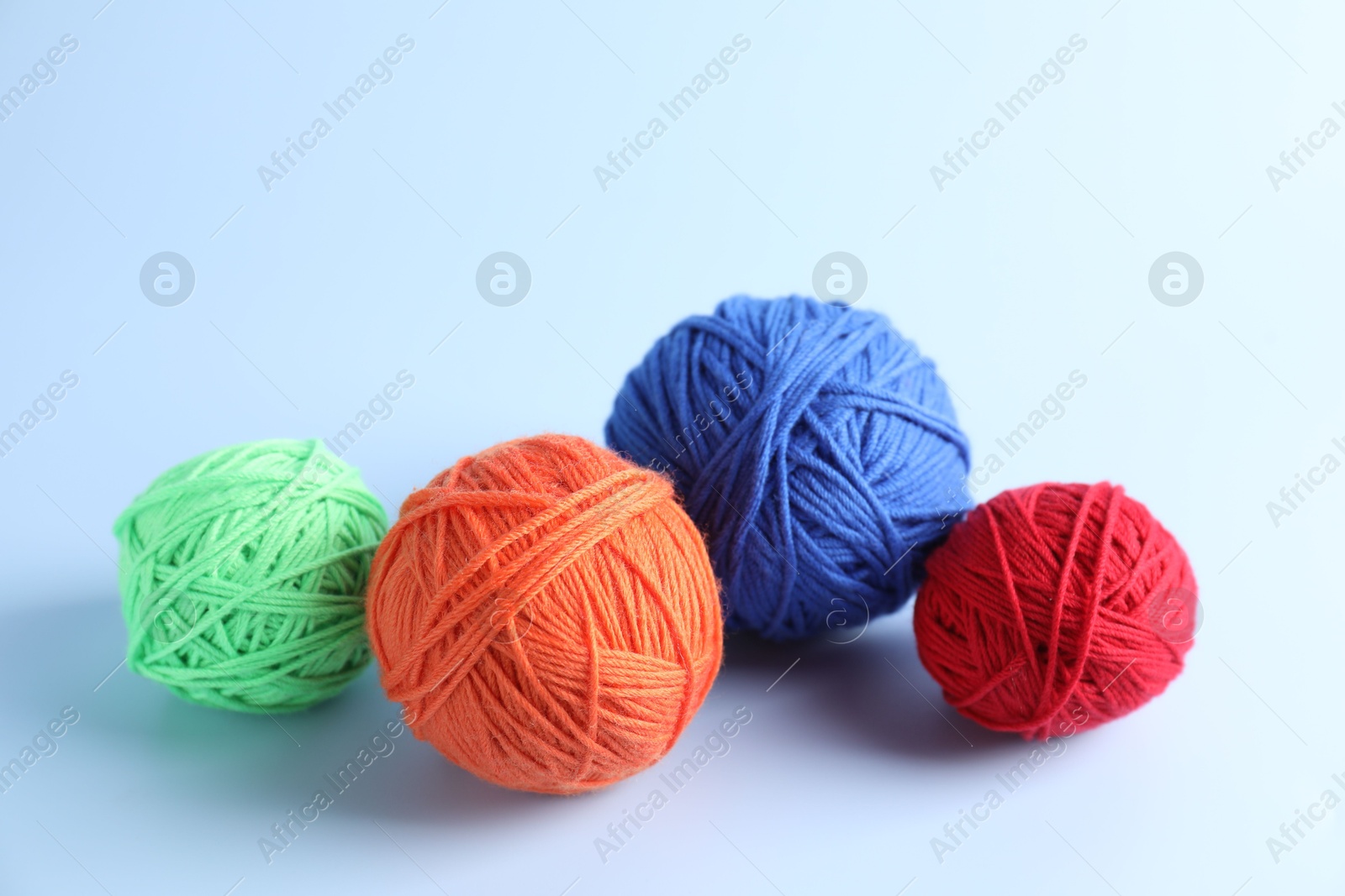 Photo of Different colorful yarns on light background. Knitting material