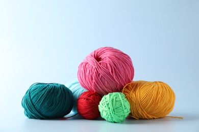 Different colorful yarns on light background. Knitting material