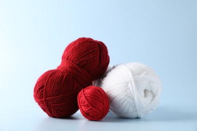 Different colorful yarns on light background. Knitting material