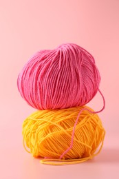 Colorful yarns on pink background. Knitting material