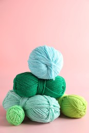 Photo of Pile of different colorful yarns on pink background