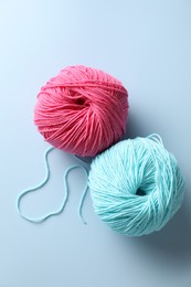 Colorful yarns on light blue background, flat lay