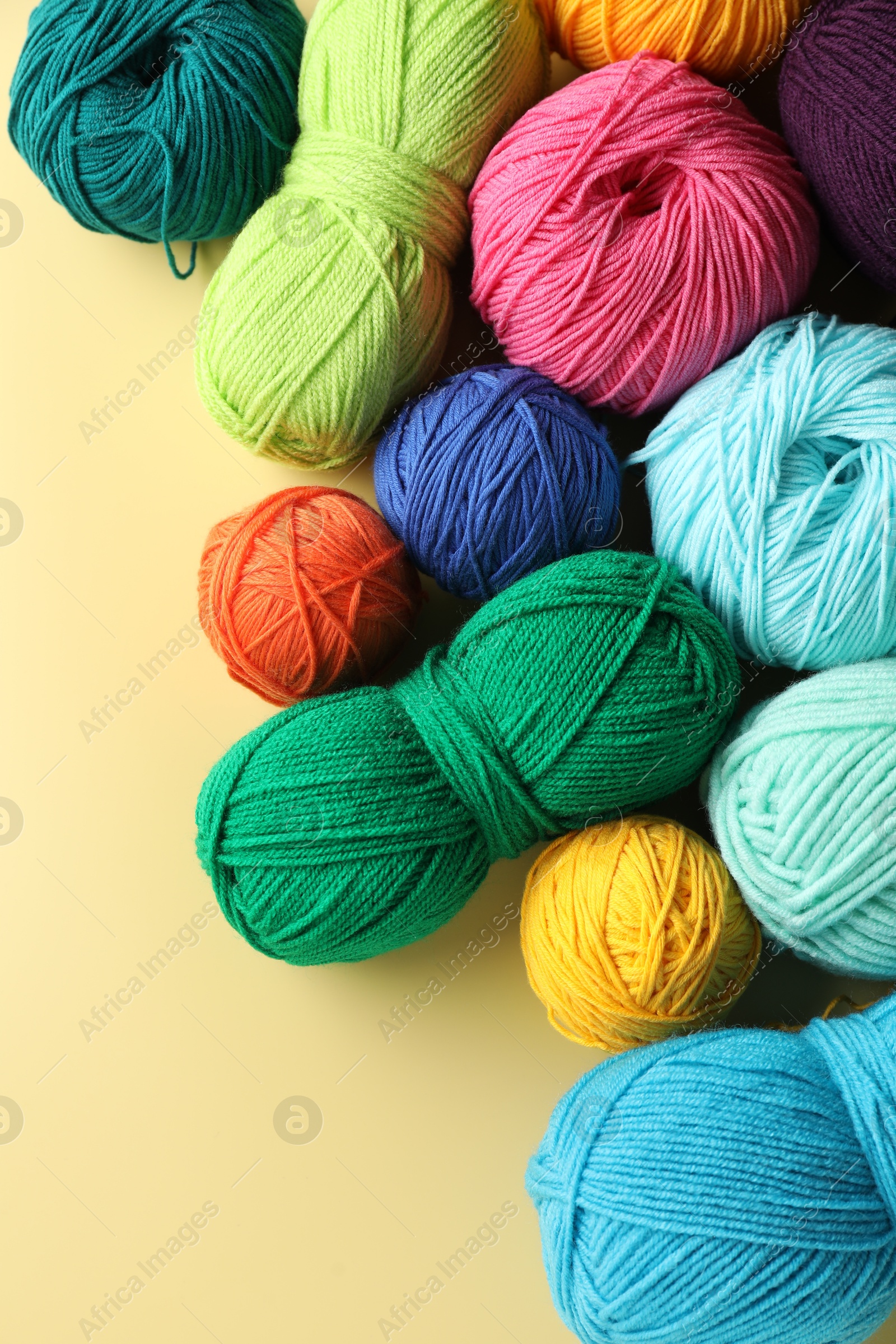 Photo of Different yarns on yellow background, flat lay