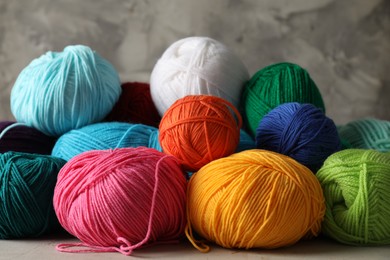 Pile of different yarns on light table, closeup