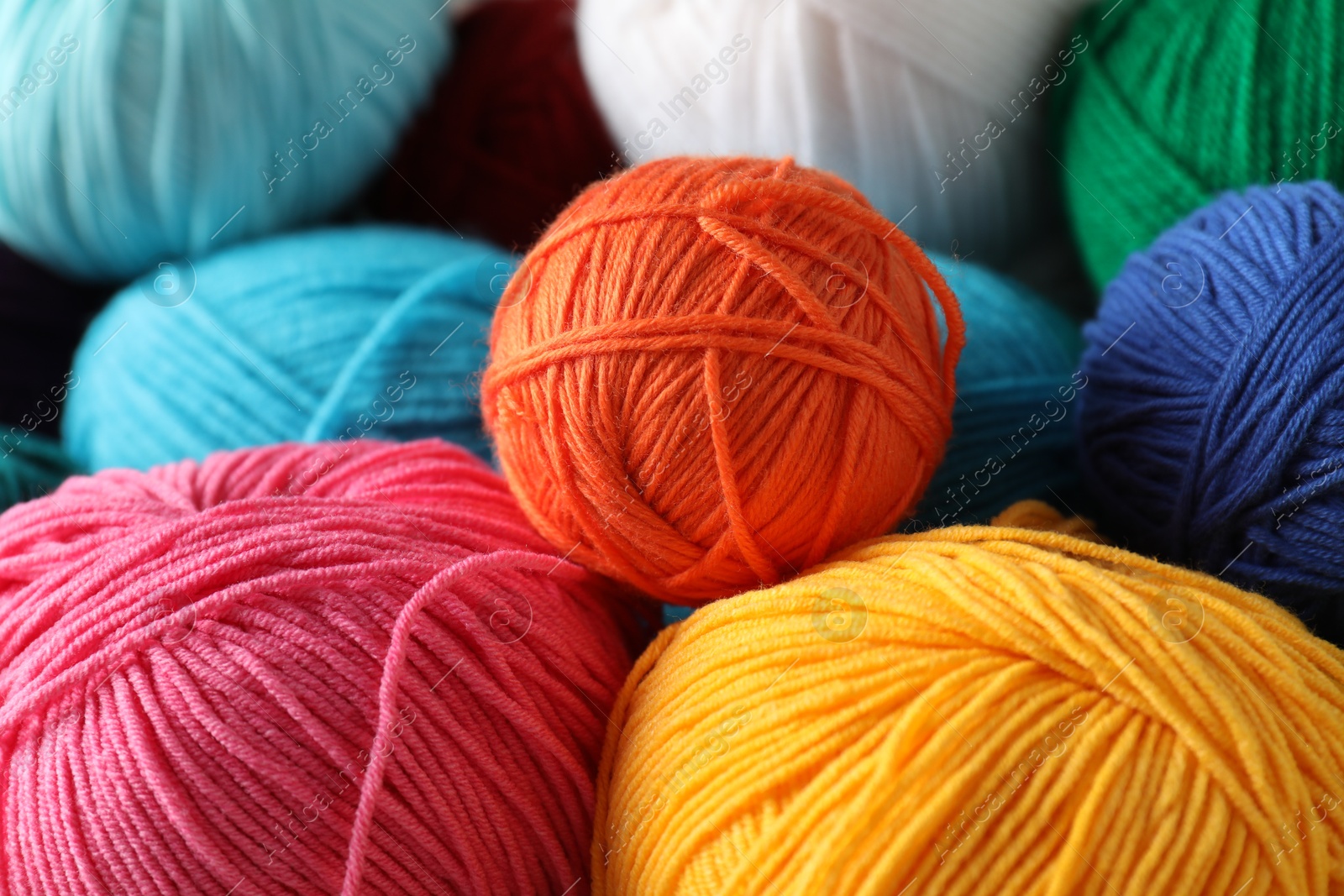 Photo of Many different yarns as background, closeup view