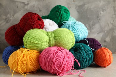 Pile of different yarns on light table, closeup