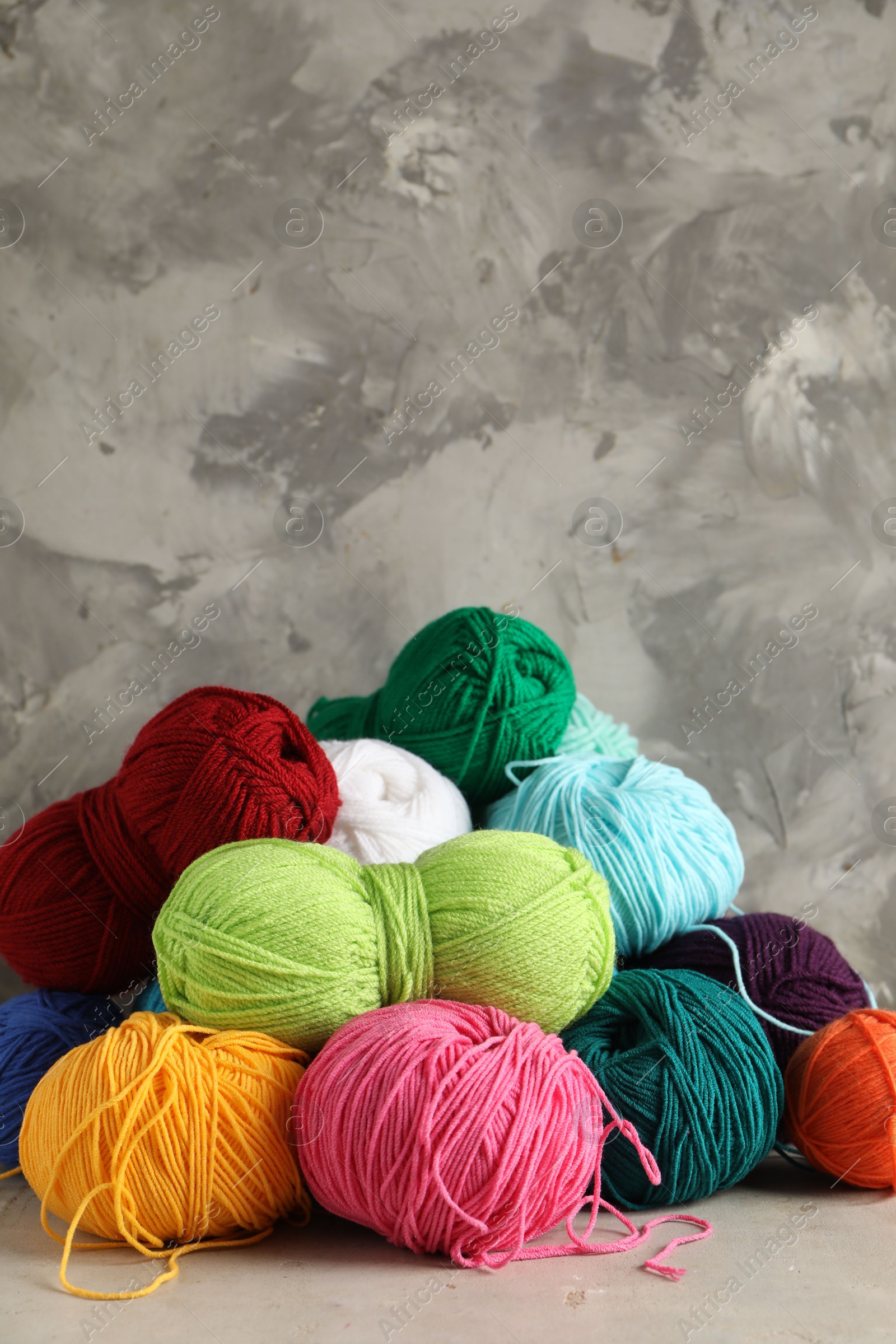 Photo of Pile of different yarns on light table. Space for text