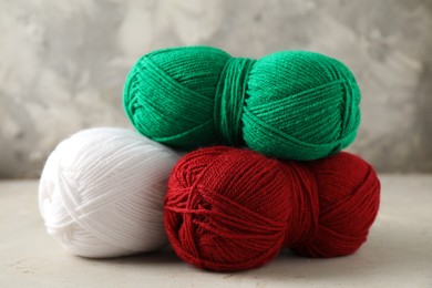 Photo of Different colorful yarns on light table, closeup