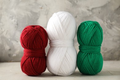 Different colorful yarns on light table, closeup