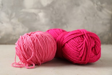 Two colorful yarns on light table, closeup