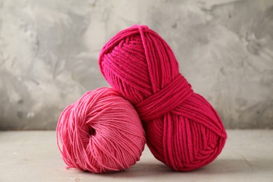 Photo of Two colorful yarns on light table, closeup