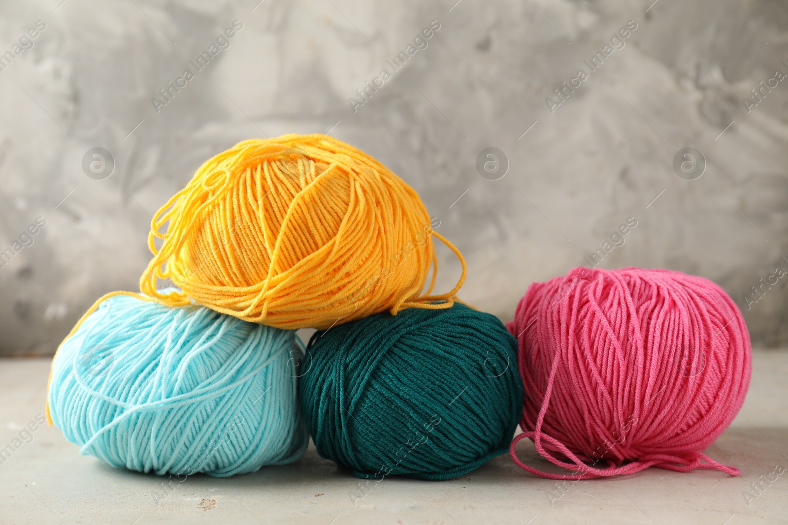 Photo of Different colorful yarns on light table, closeup