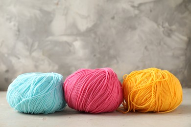 Photo of Different colorful yarns on light table, closeup. Space for text