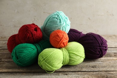 Photo of Pile of different yarns on wooden table