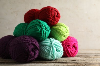 Photo of Pile of different yarns on wooden table