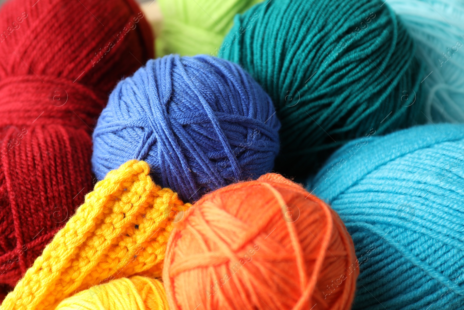 Photo of Many different yarns and knitting sample as background, closeup