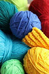 Photo of Many different yarns and knitting sample as background, above view