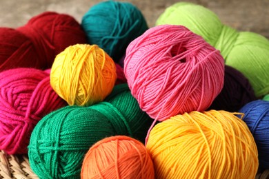 Photo of Many different yarns on blurred background, closeup