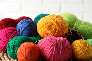 Photo of Many different yarns on blurred background, closeup