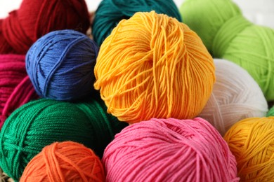 Many different yarns on blurred background, closeup