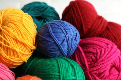 Photo of Many different yarns on blurred background, closeup