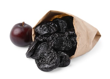 Photo of Paper bag with delicious prunes and fresh ripe plum isolated on white