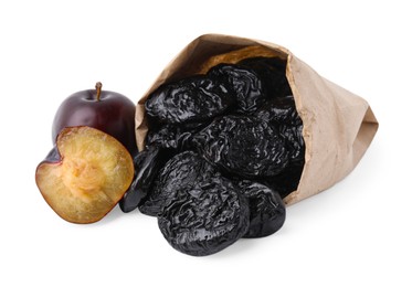 Photo of Paper bag with delicious prunes and fresh ripe plums isolated on white