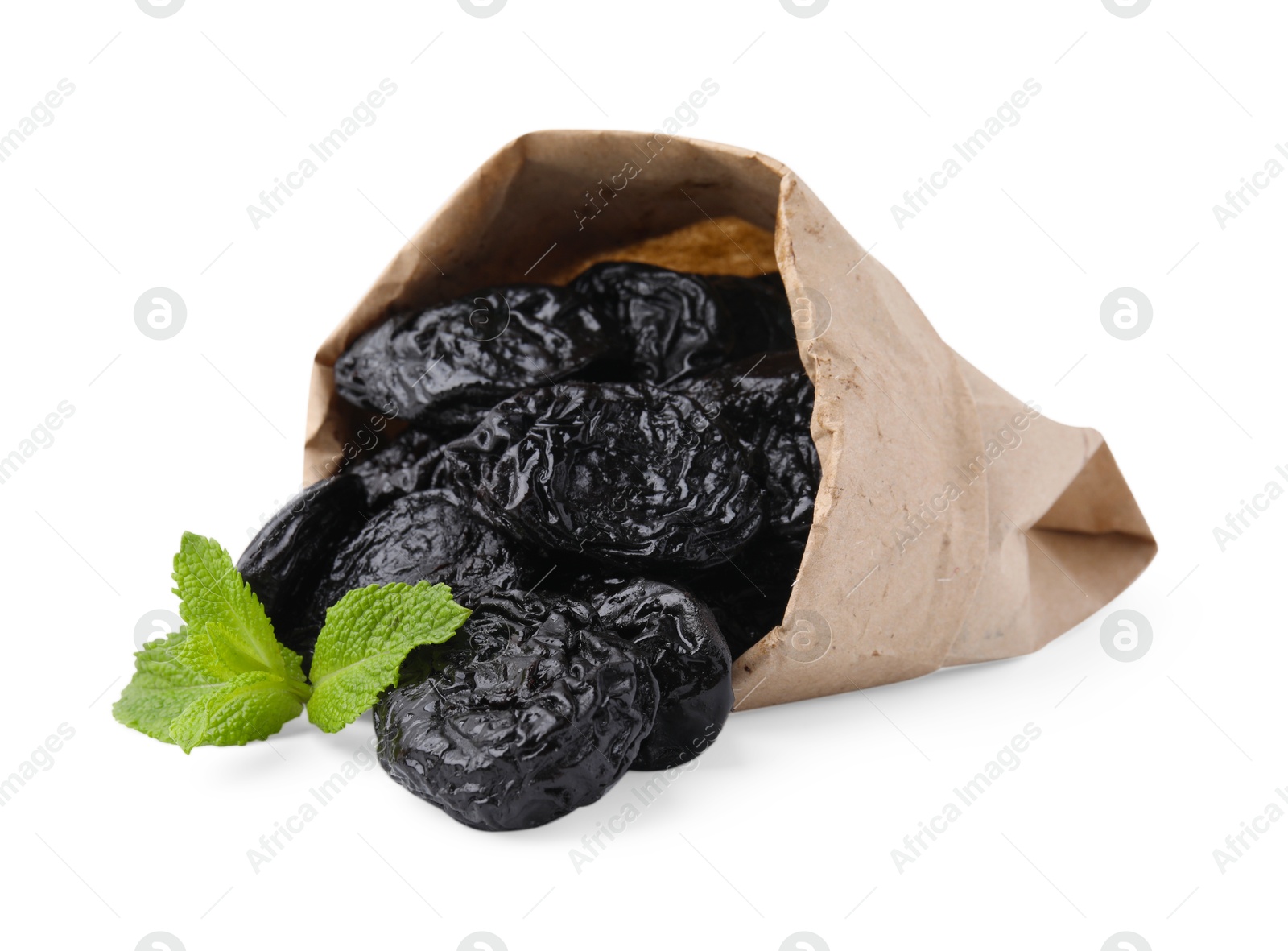 Photo of Paper bag with tasty dried plums (prunes) and mint isolated on white