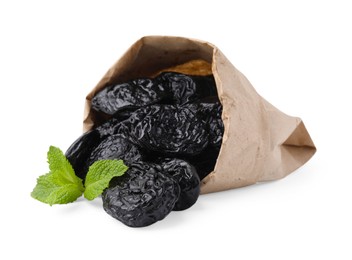 Photo of Paper bag with tasty dried plums (prunes) and mint isolated on white