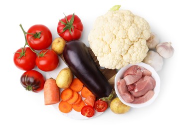 Photo of Different vegetables and raw meat for stew isolated on white, top view