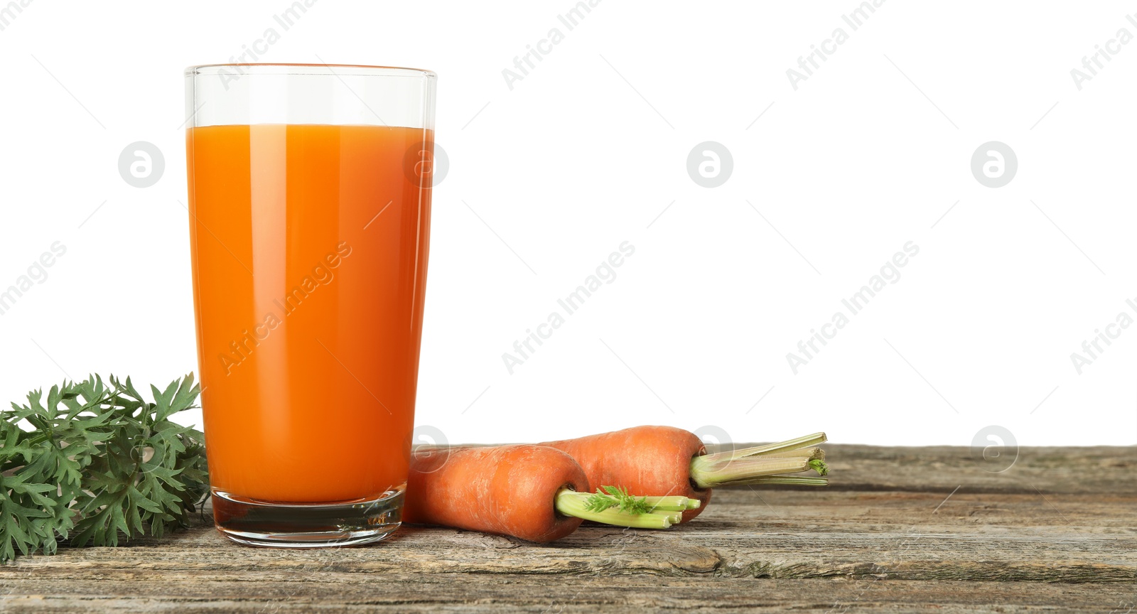 Photo of Fresh carrot juice in glass and vegetables on wooden table against white background. Space for text