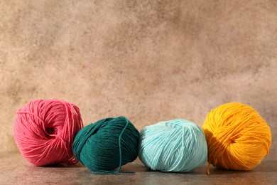 Photo of Many soft skeins of yarn on light brown background, space for text