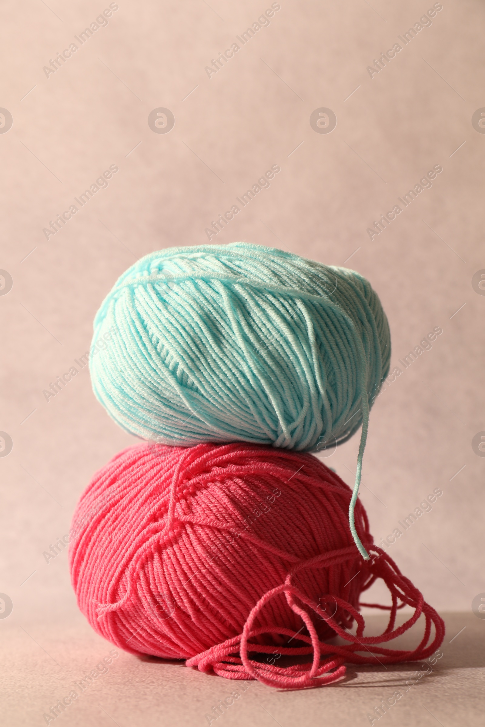 Photo of Two soft skeins of yarn on beige background