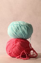 Two soft skeins of yarn on beige background