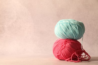 Photo of Two soft skeins of yarn on beige background, space for text