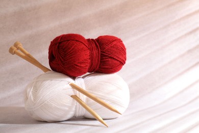 Two soft skeins of yarn on beige background