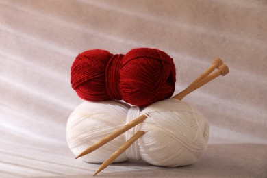 Photo of Two soft skeins of yarn on beige background