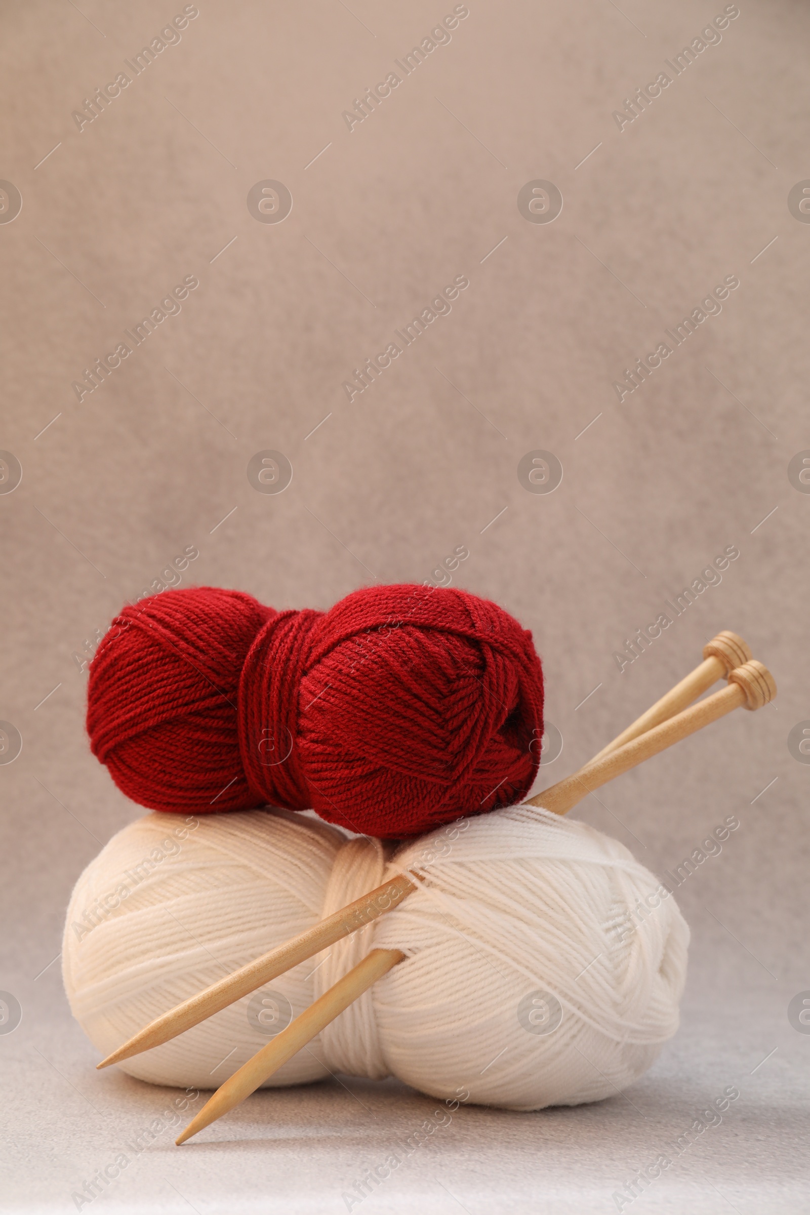 Photo of Two soft skeins of yarn on beige background