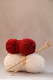 Two soft skeins of yarn on beige background