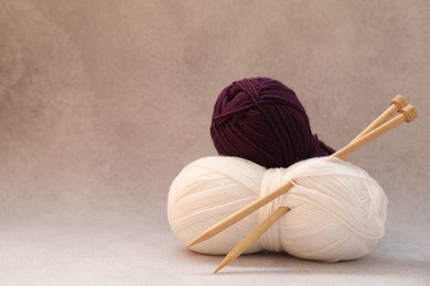 Two soft skeins of yarn on beige background