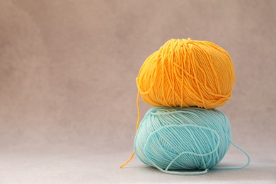 Two soft skeins of yarn on beige background, space for text